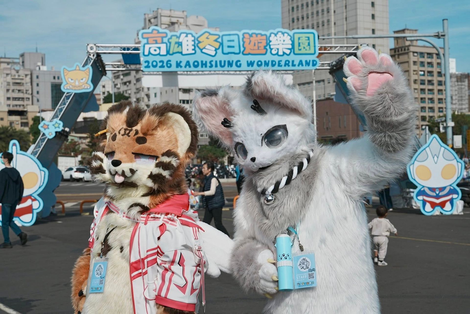 虎紋與白色狼型獸裝角色在「高雄冬日遊樂園 2026 KAOHSIUNG WONDERLAND」拱門前揮手合影